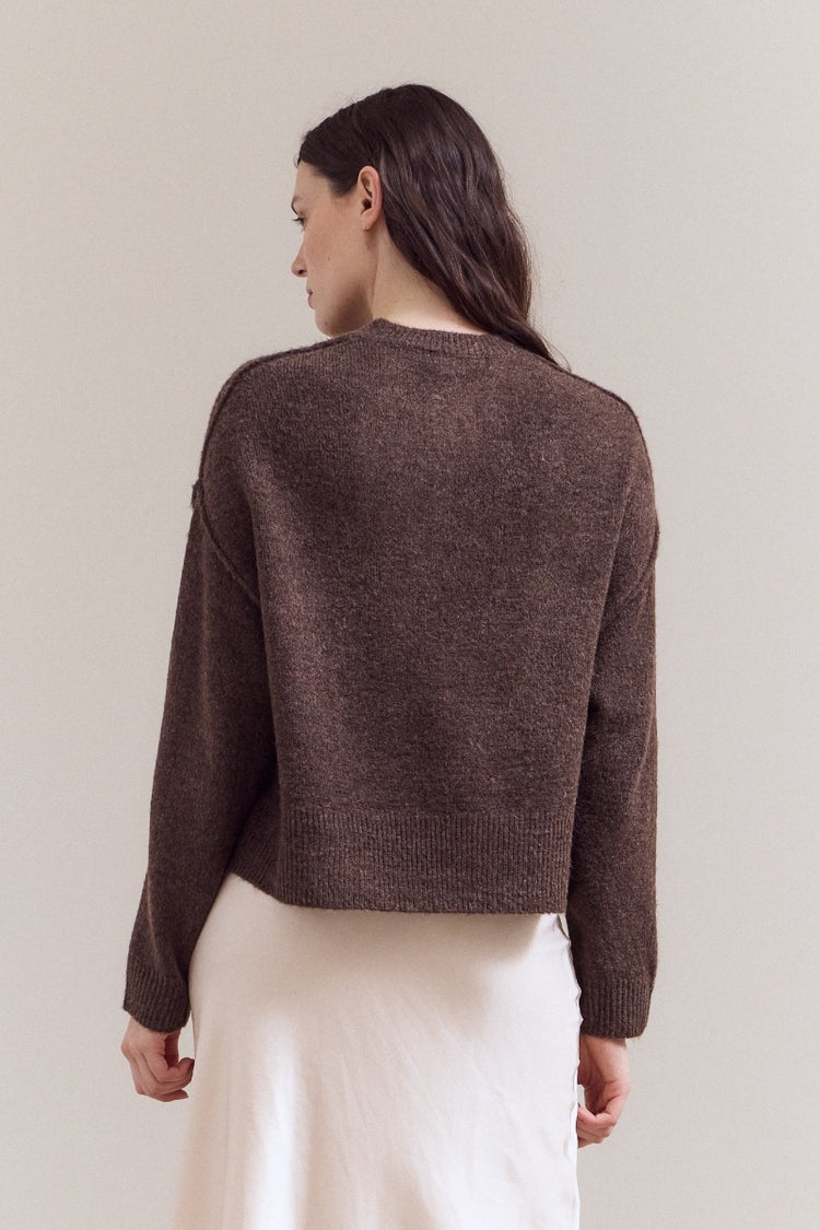 Natasha half button down sweater in a soft neutral tone with long sleeves and a relaxed silhouette.