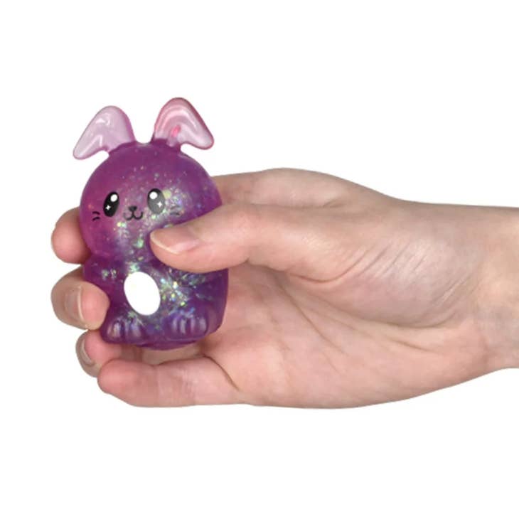 Squeezy Sugar Easter Bunny squishy toy in pastel pink with white ears and a black nose.