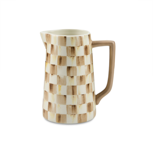 Ceramic farmhouse pitcher with a brown and cream hand-painted check pattern and a square handle.