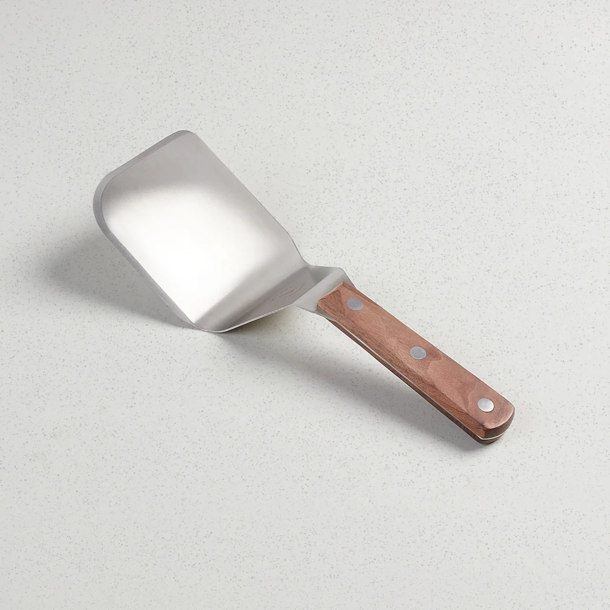 Mighty Spatula with a stainless steel blade and a full tang walnut handle with three rivets.