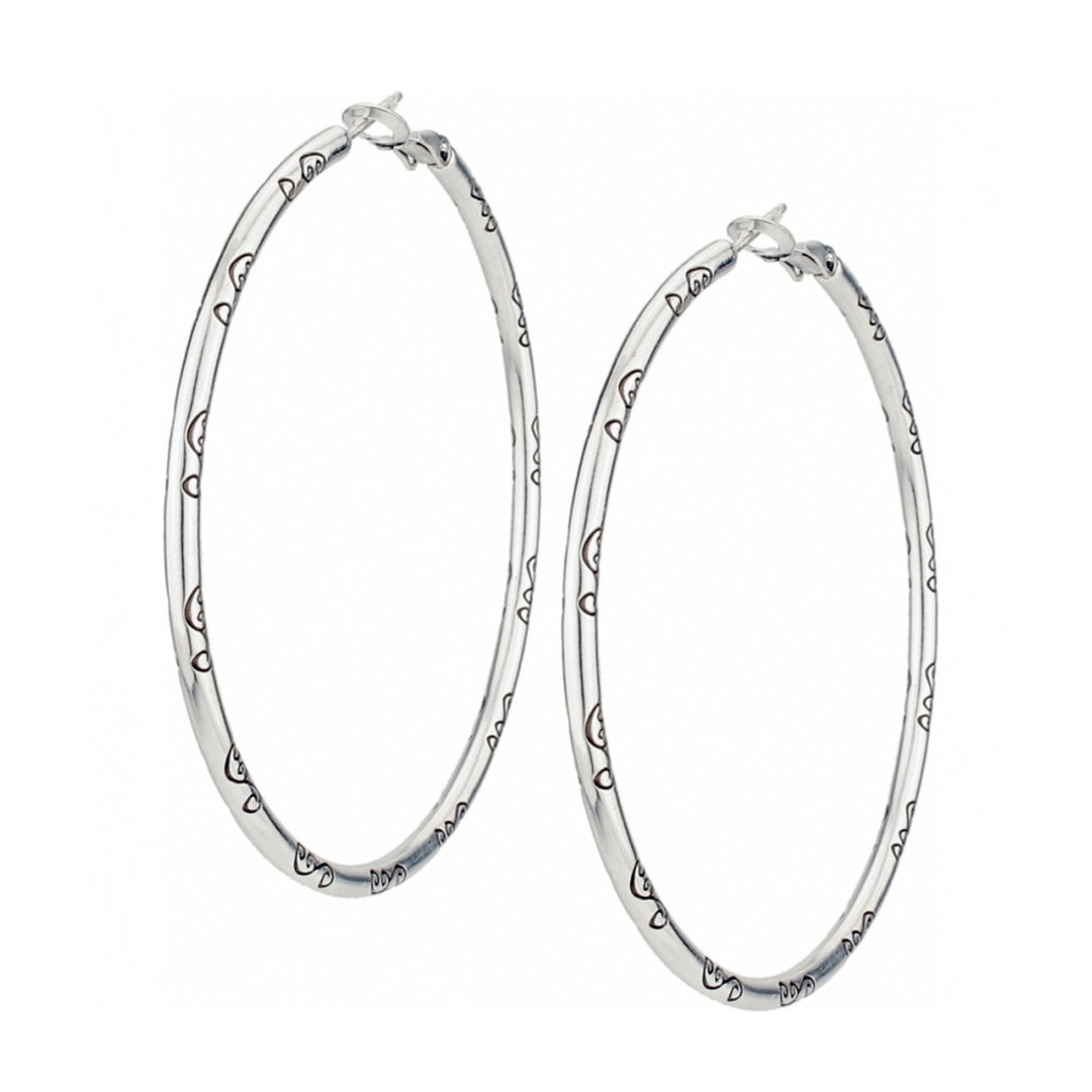Silver plated Grande Charm Hoop Earrings with engraved heart patterns and a 2 1/2 inch drop.