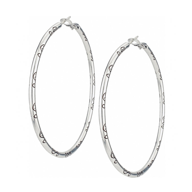Silver plated Grande Charm Hoop Earrings with engraved heart patterns and a 2 1/2 inch drop.