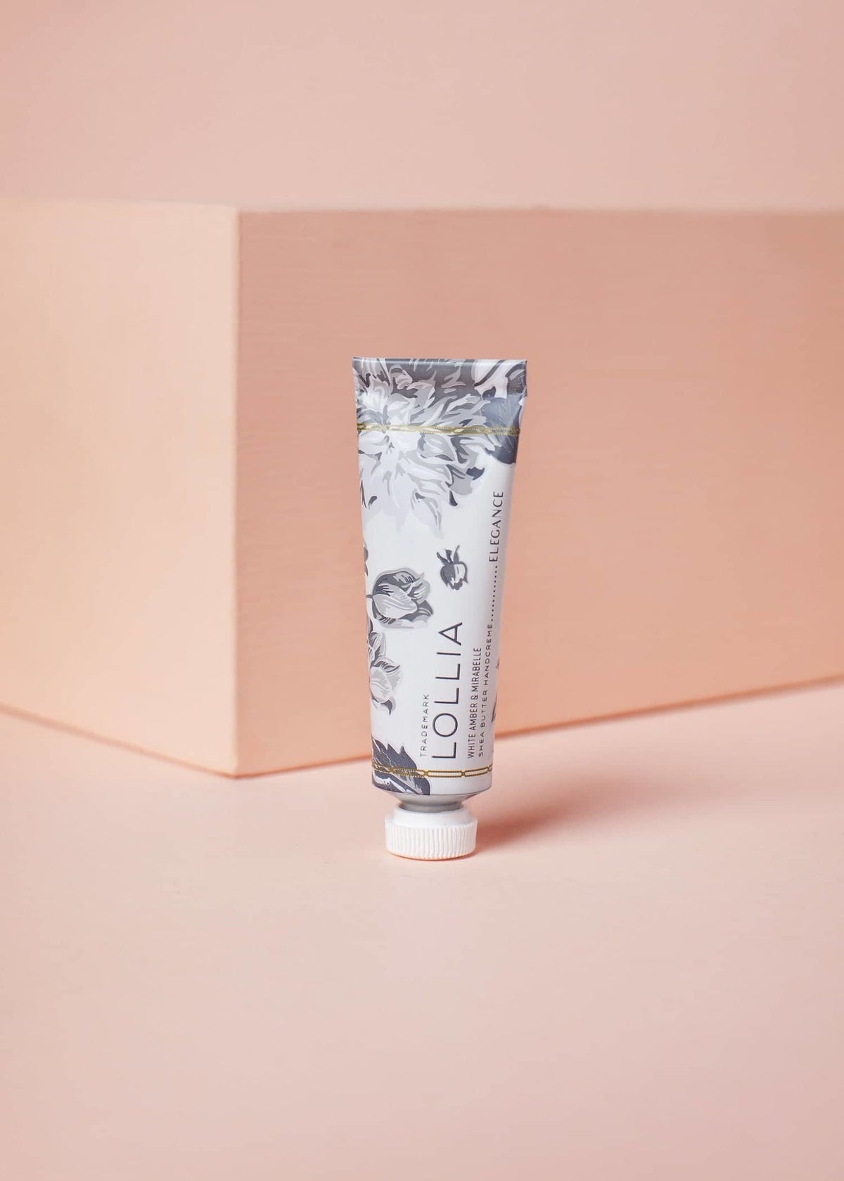 Petite Elegance hand cream tube with white cap featuring shea butter and avocado oil ingredients.