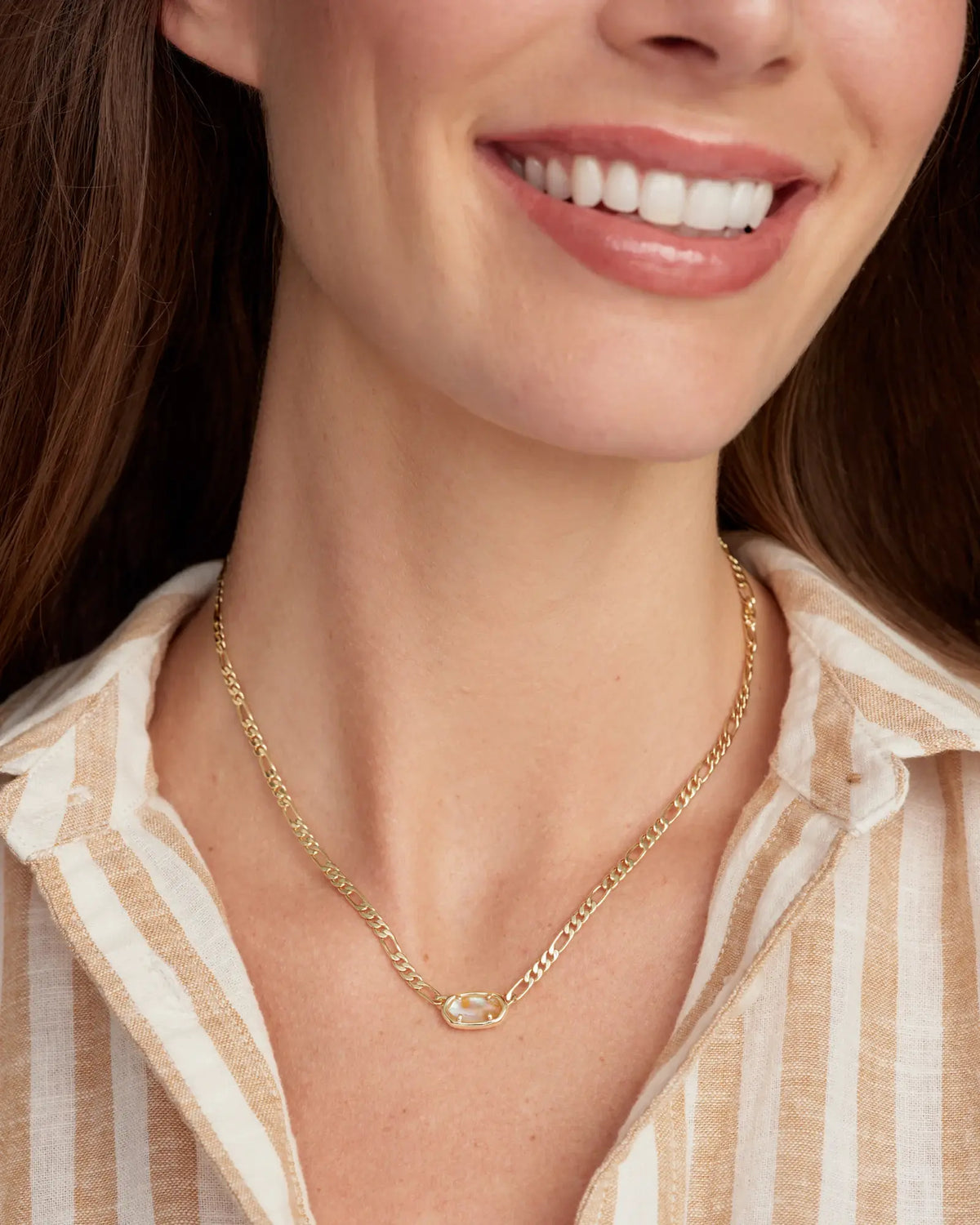 Short silver Figaro chain necklace with a small pendant.