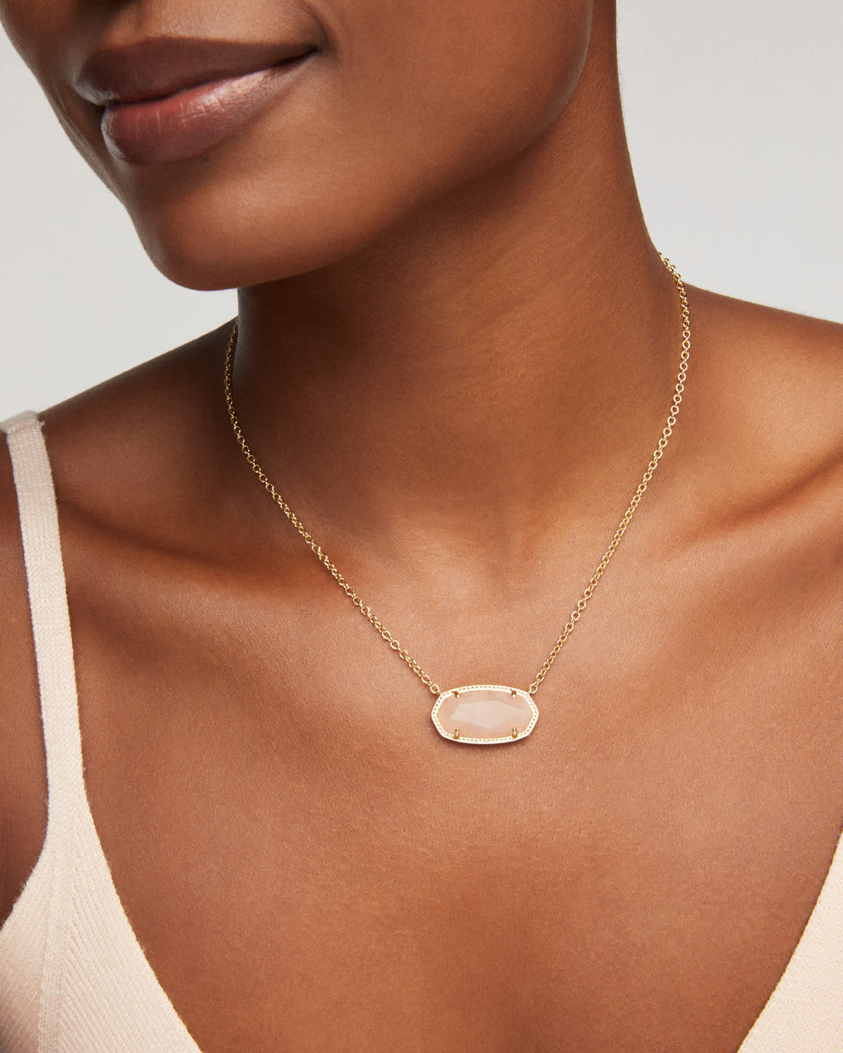 Gold-toned Elisa statement short pendant necklace with a rectangular bezel-set stone on an adjustable chain.