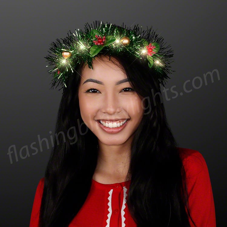 Woman wearing a Christmas Crown LED Tinsel Wreath Headband with warm white lights and red berries.