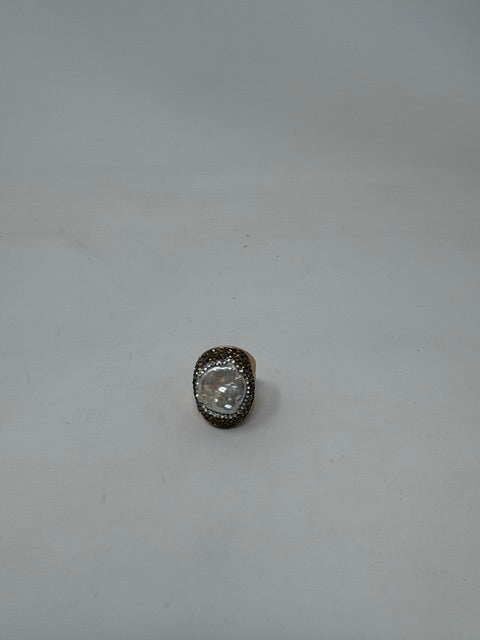 Fashion gemstone ring featuring a large oval white pearl center surrounded by dark crystal pavé.