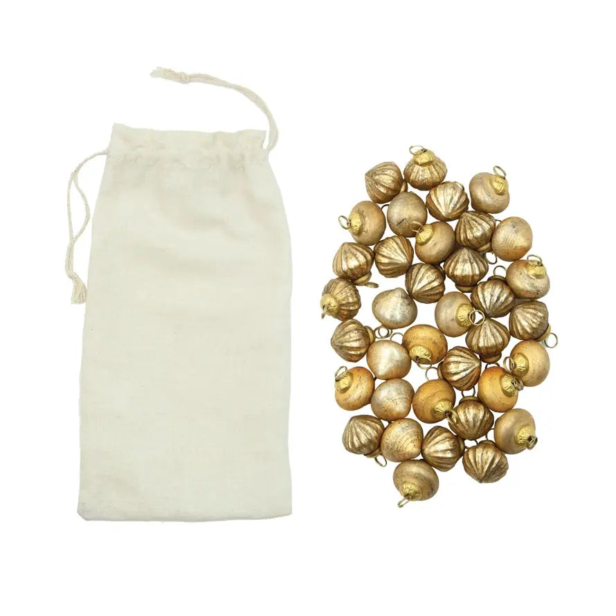 Set of embossed mercury glass ornaments with vintage finish in a muslin bag.