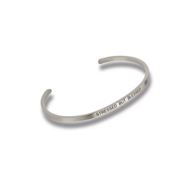 Silver stress ball bracelet with 'Stressed but Blessed' engraved text on a circular silhouette.