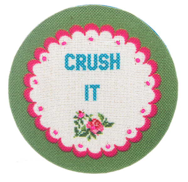 Multi-colored embroidered compact mirror with a circular shape.