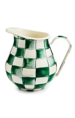 Hand-glazed steel pitcher with emerald checkered pattern on a dark background.