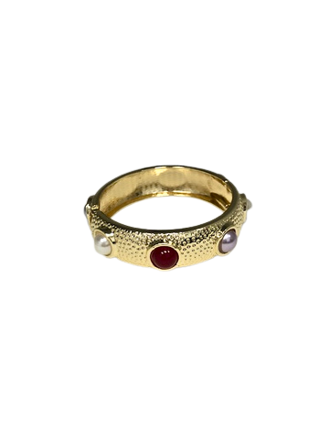 Gold hinged cuff bracelet with a textured finish and inset red, white, and purple cabochon stones.
