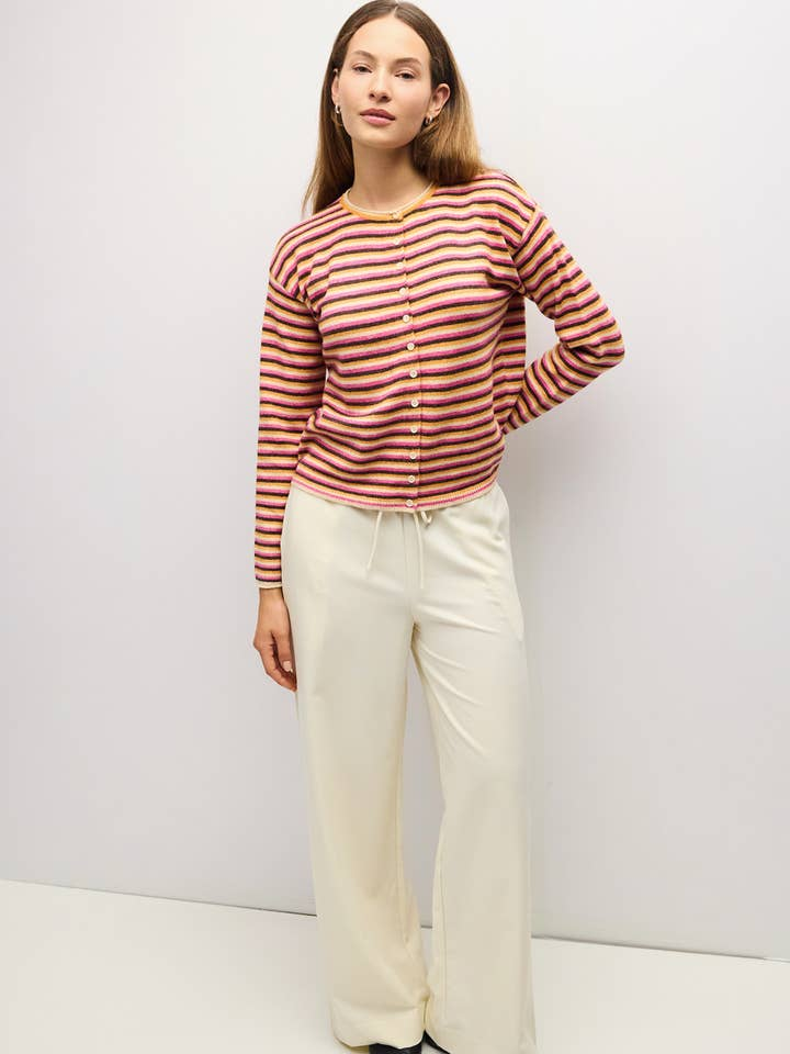 Woman wearing the Cathy Cardigan, a multi-color striped knit with a button front and relaxed fit.