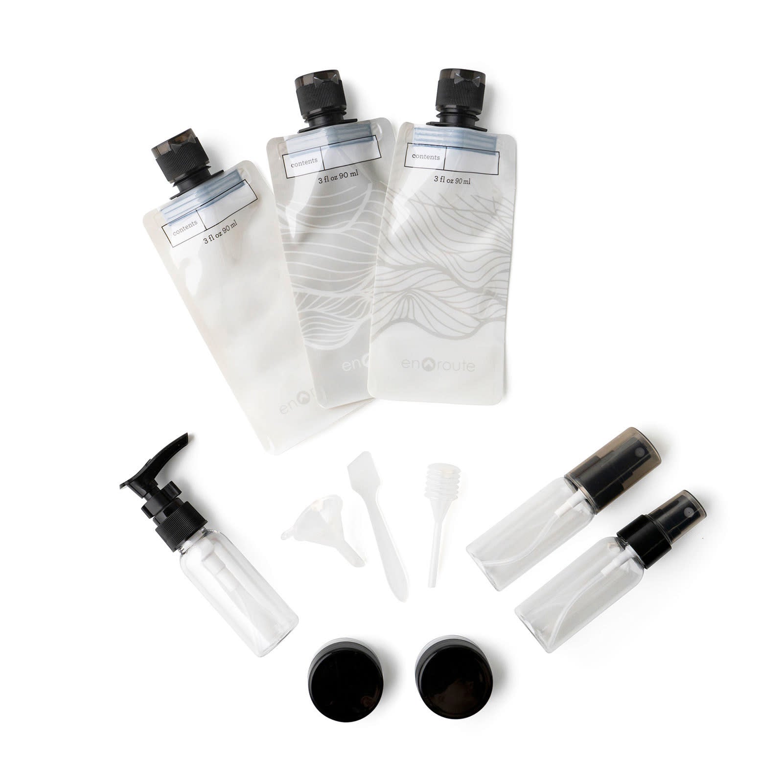 Gray reusable travel kit with squeeze pouches, spray bottles, pump bottle, mini jars, dropper, funnel, and scraper.