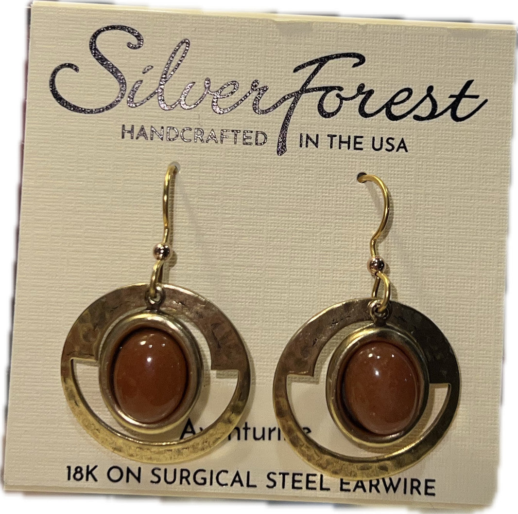 Hammered gold-tone frame earrings with oval brown stones on a Silver Forest display card.