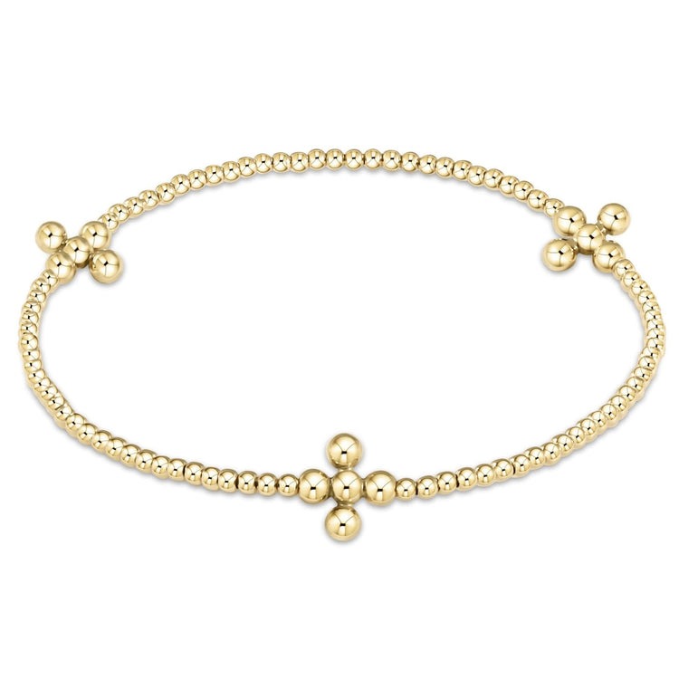 Gold-filled beaded bracelet with a signature cross pendant on elastic cord