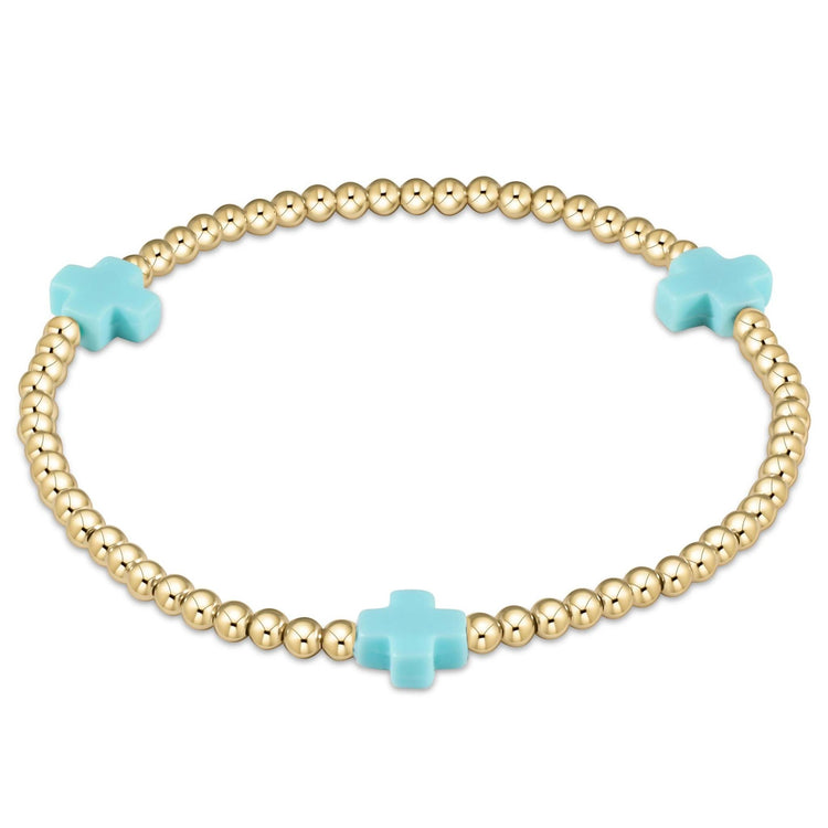 Enewton bracelet with gold-filled beads in a signature cross pattern on elastic cord