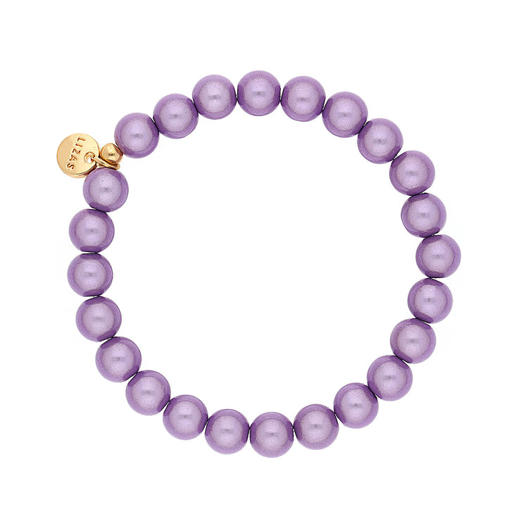 Lizas Essentials Roundville purple pearl stretch bracelet with a gold logo charm.
