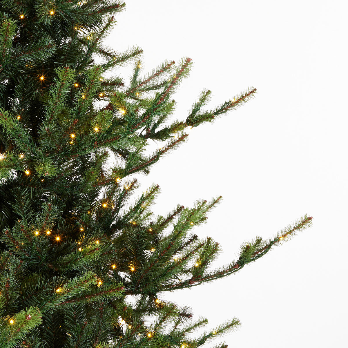 Close-up of a 9' Pre-Lit Deluxe Rocky Mountain Spruce Tree with warm white LED lights.
