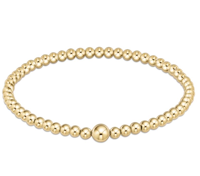 Classic gold-tone bangle bracelet featuring a continuous row of round beads.