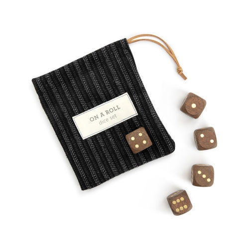 Brown wooden dice set with gold pips in a black pinstripe drawstring bag labeled "ON A ROLL dice set".