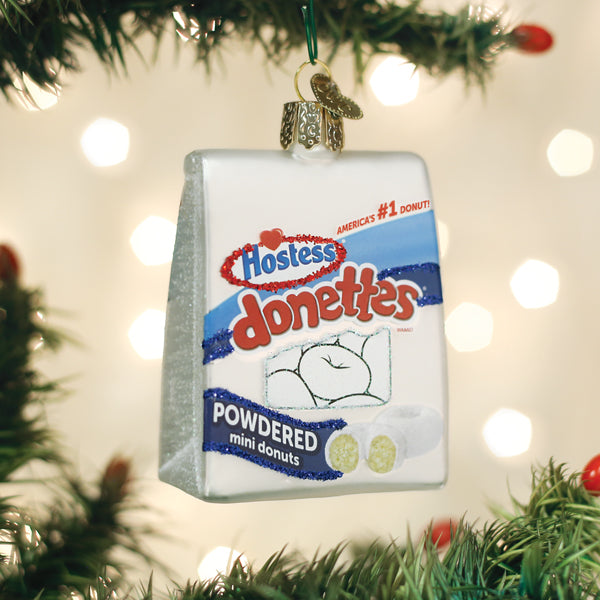 Glass Hostess Donettes powdered mini donuts bag Christmas ornament hanging on a tree.