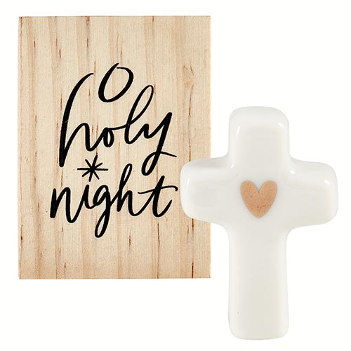 White ceramic cross with a gold heart next to a pine wood box reading O Holy Night.