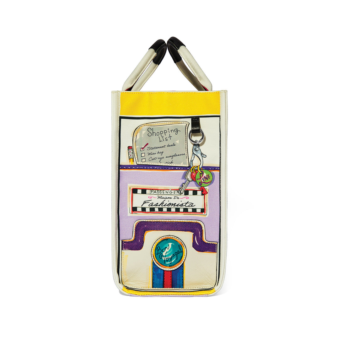 Side view of a large canvas tote with colorful travel-themed artwork and a shopping list design.