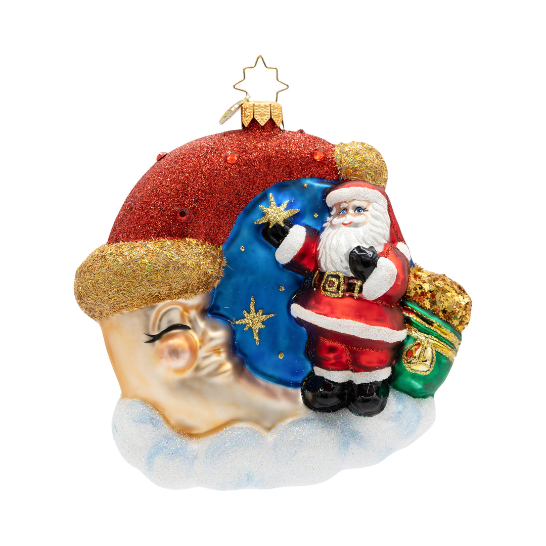 Crescent Wishes Santa glass ornament featuring Santa on a glittering moon with a sack of toys.