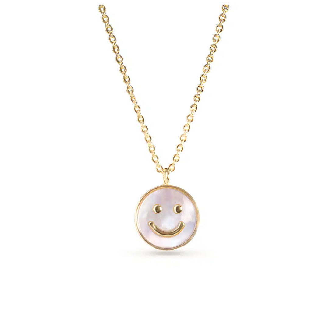 Gold chain necklace with a circular mother of pearl pendant featuring a gold smiley face.