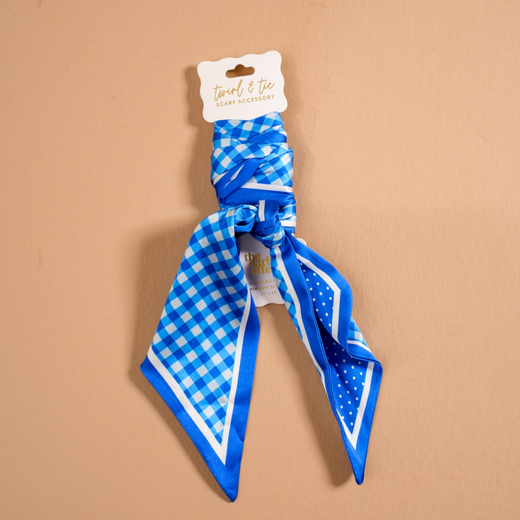Blue and white gingham and polka dot satin scarf accessory on a white display card.