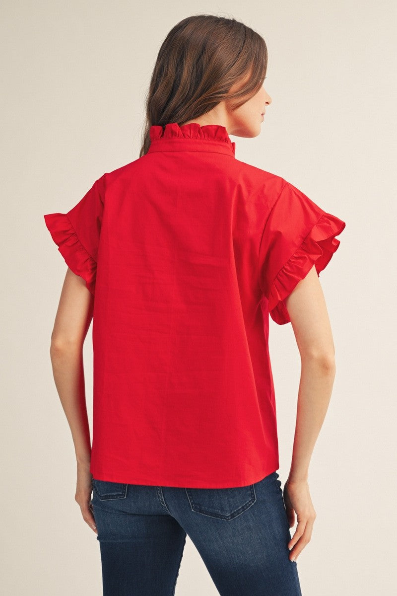 Back view of a woman wearing a red Elise Ruffled Detail Woven Top with blue jeans.