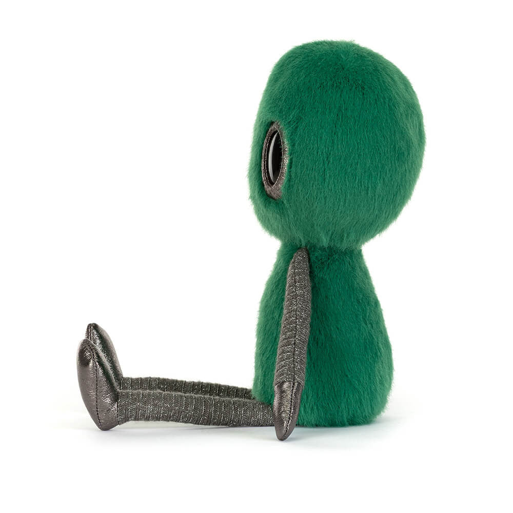 Side view of Zyllan Alien, a green fuzzy plush toy with metallic grey arms and legs.
