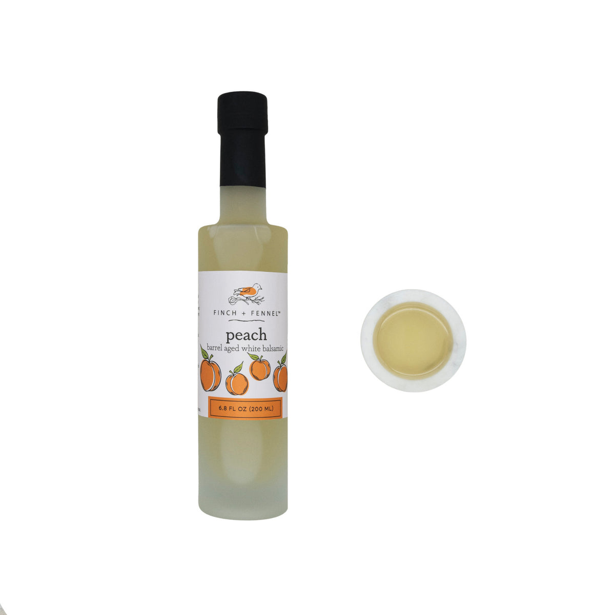 6.8 oz bottle of peach barrel aged white balsamic vinegar with a clear glass silhouette and gold cap.
