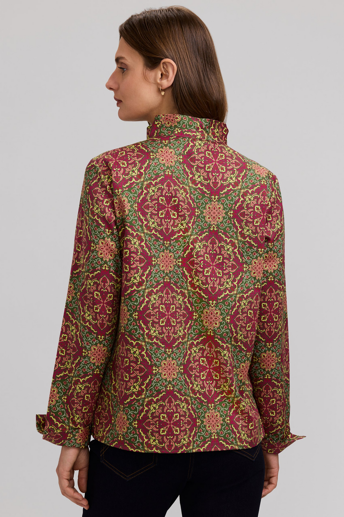 Back view of a woman wearing the Tammy Fall Medallion long sleeve popover in a red and green print.