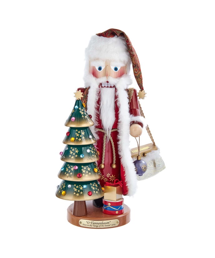 Wooden musical nutcracker featuring Santa Claus standing beside a decorated Christmas tree holding a blue ornament.