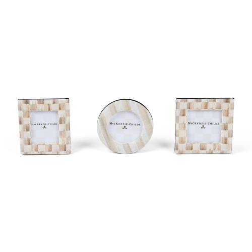 Set of three MacKenzie-Childs fabric-covered frames in square and round shapes with check patterns.