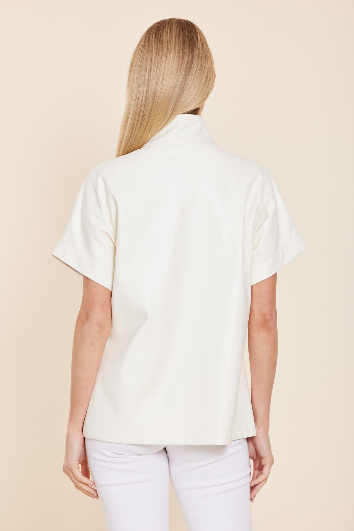 Angela faux leather zip-up top in black with a relaxed fit.