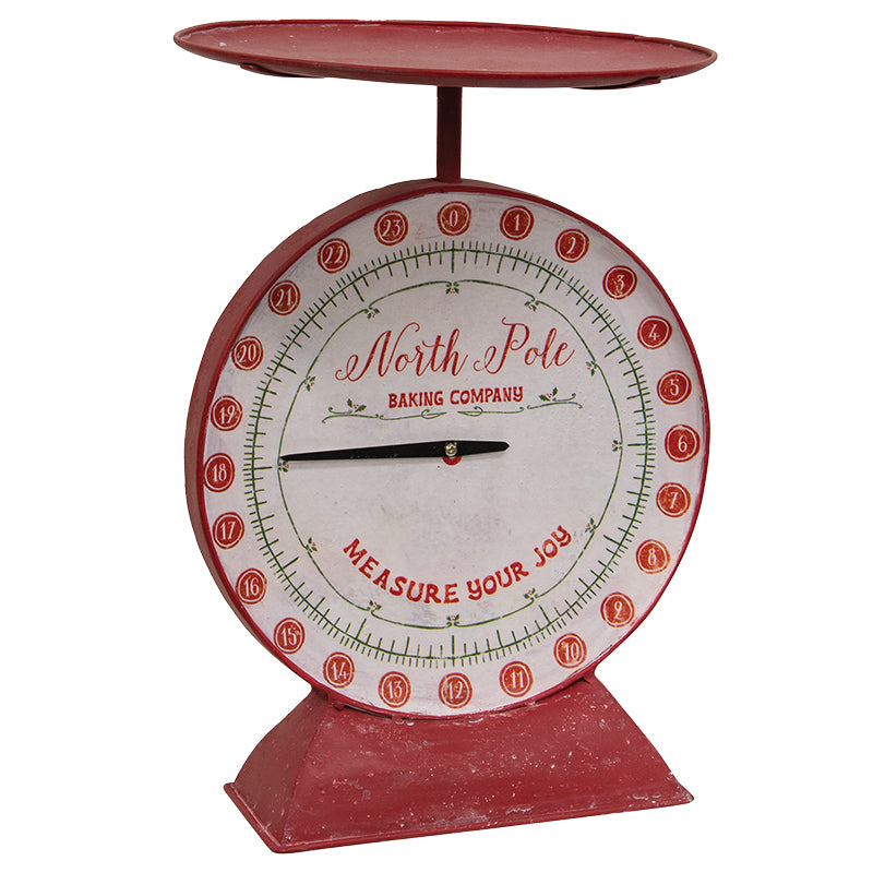 Red metal kitchen scale with a circular dial face and silver measuring cups on top.