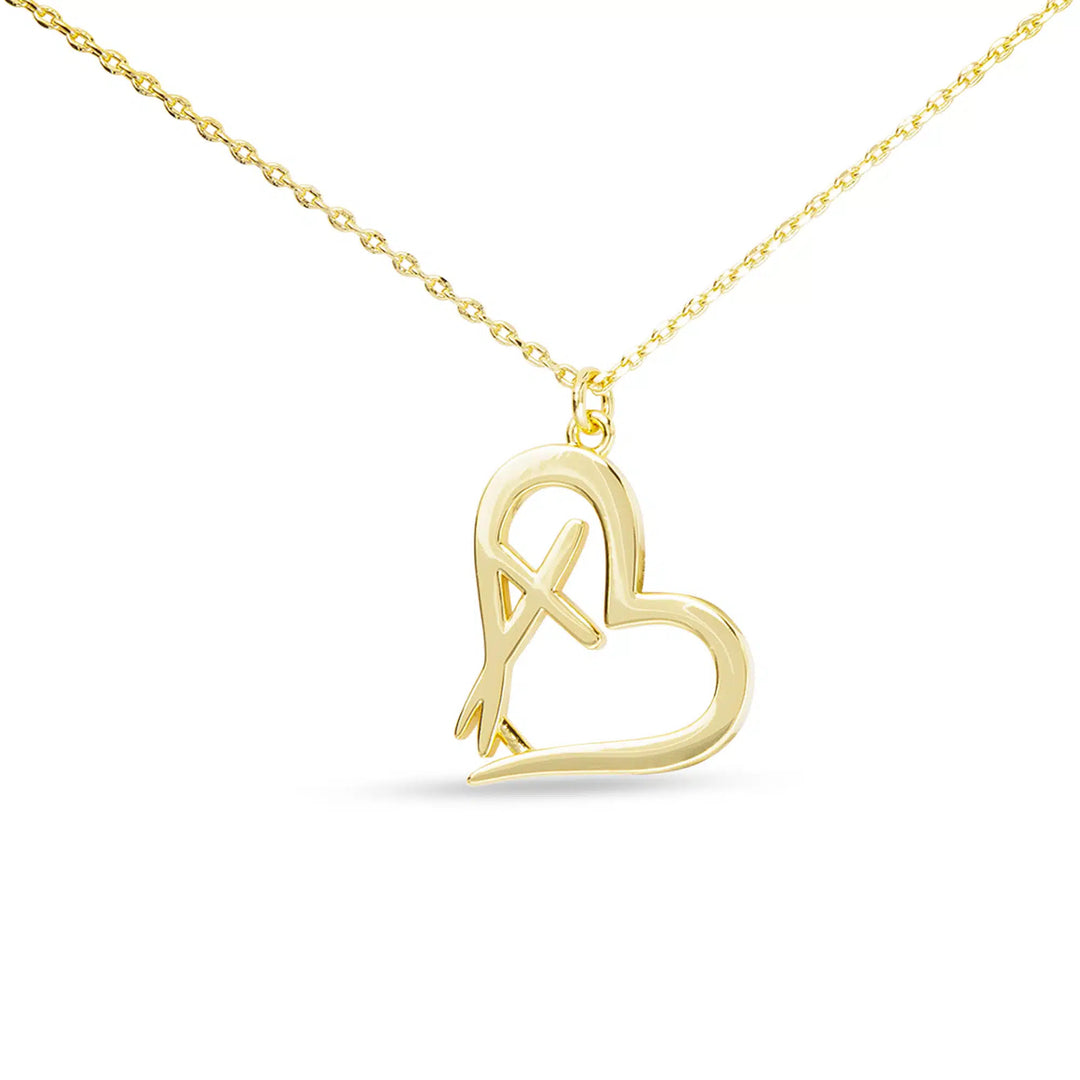 Gold necklace with a heart-shaped pendant featuring an integrated cross design.