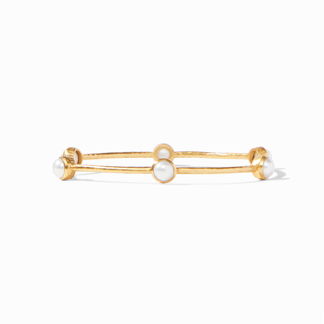 Lightly hammered gold bangle with six iridescent gemstone stations.