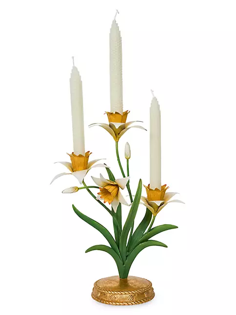 Yellow metal candelabra centerpiece with resin daffodil flowers on a curved stem