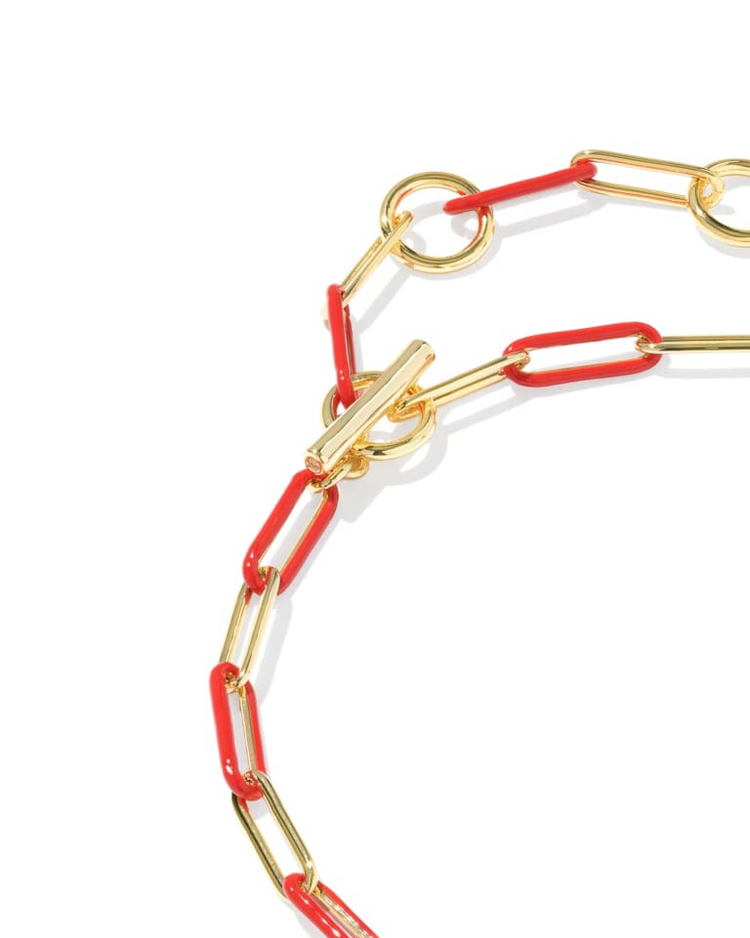Courtney gold bracelet with alternating red enamel and gold paperclip links and a toggle closure.