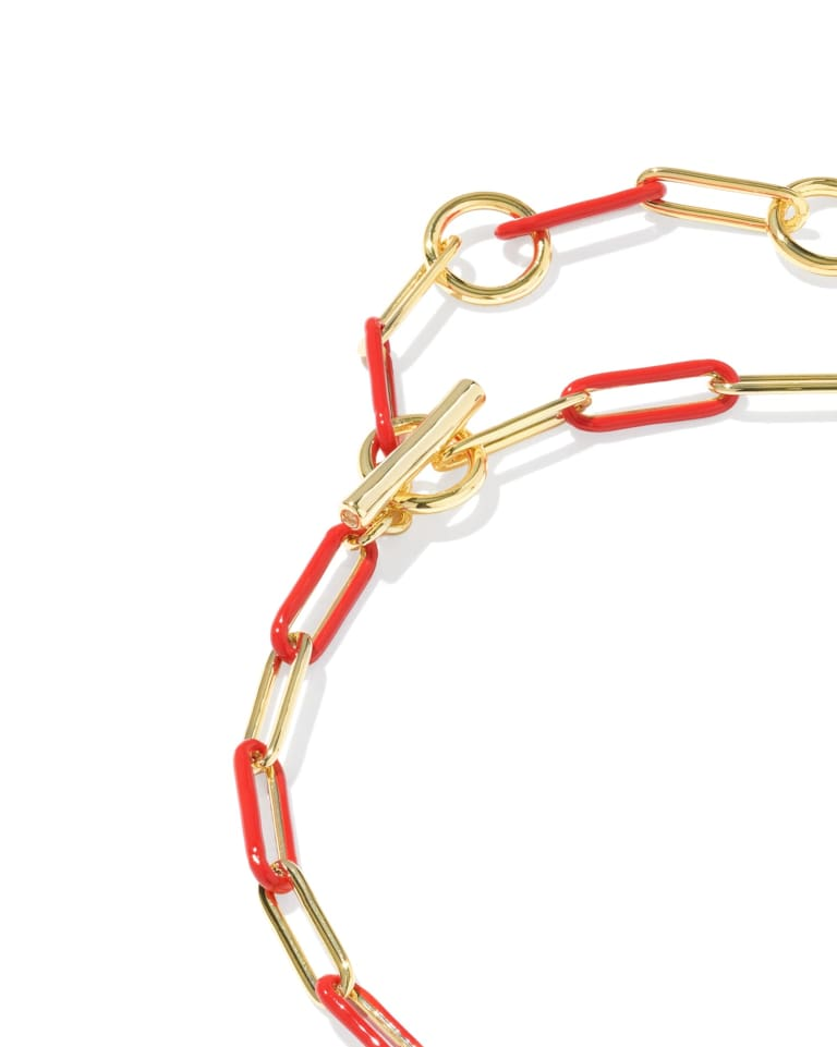 Courtney gold bracelet with alternating red enamel and gold paperclip links and a toggle closure.