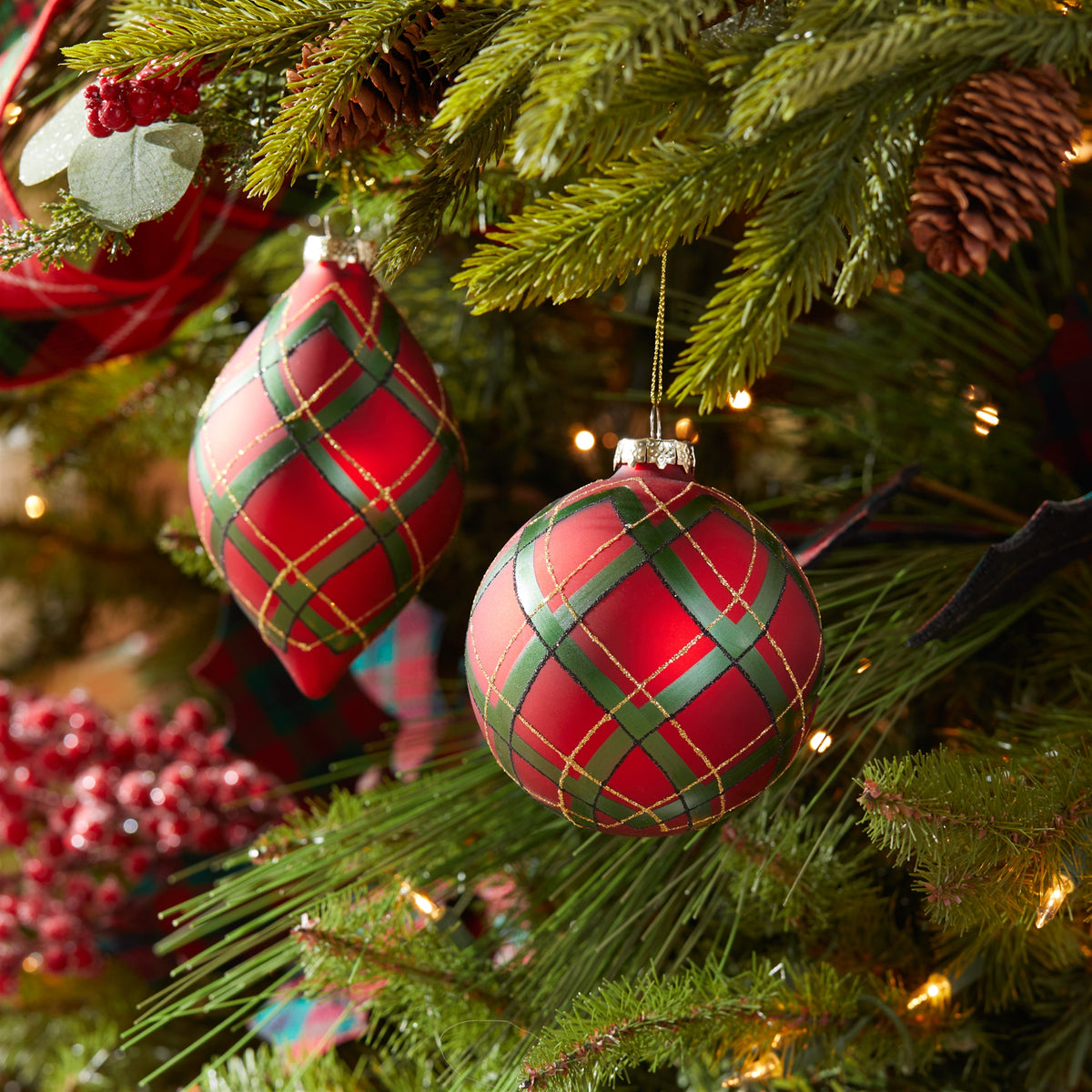 Glass ornament with classic plaid pattern in festive colors