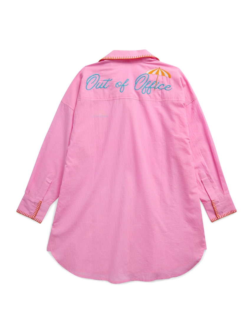 Oversized white cotton button-down cover-up shirt with embroidered 'Vacay' text on front pocket and 'Out of Office' across back.