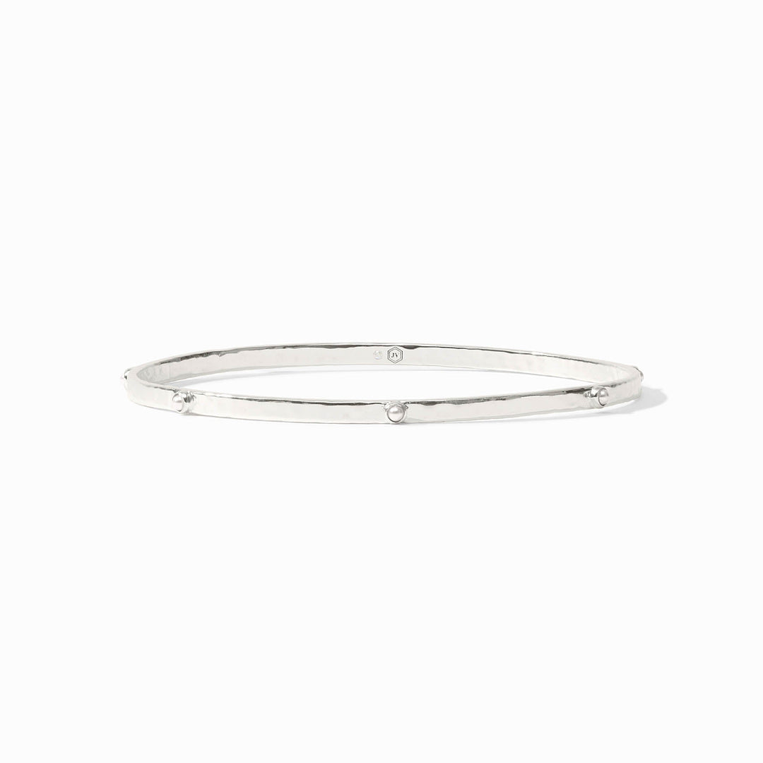 Lightly hammered gold bangle with gemstone stations.