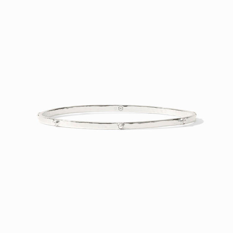 Lightly hammered gold bangle with gemstone stations.