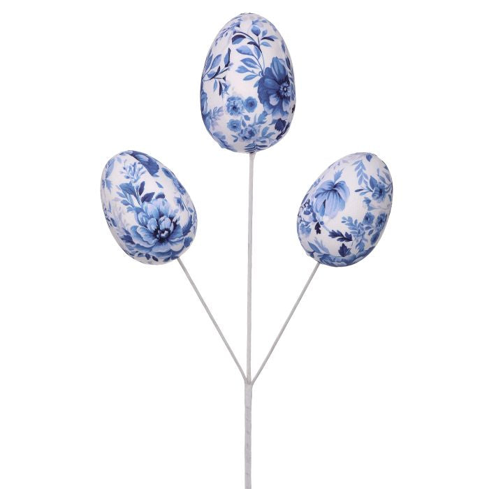 Three decorative eggs wrapped in blue and white toile fabric with floral botanical illustrations.