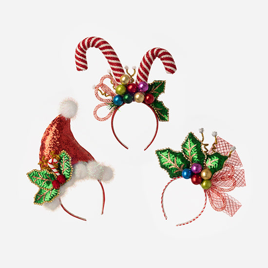 Three Christmas-themed headbands: Santa hat, candy canes, and holly with ornaments.
